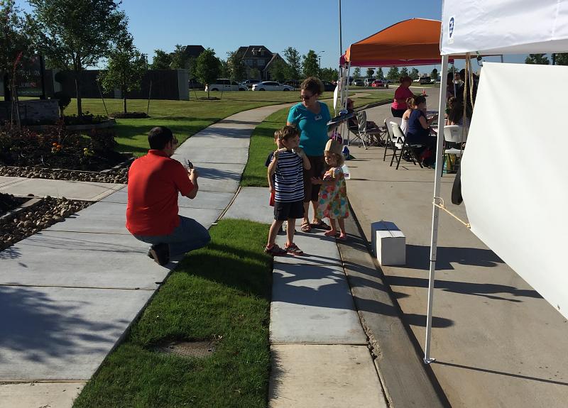 Family explores Farmers Market, held weekly in Fort Bend at Harvest Green.