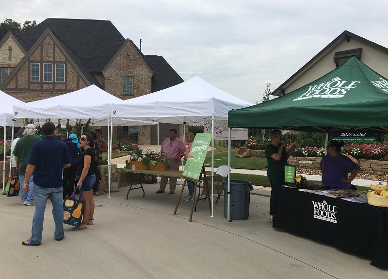Whole Foods and other vendors run stands during Harvest Green's Farmers Market.