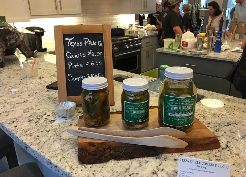 Samples of Texas pickles are offered inside a Harvest Green model home.