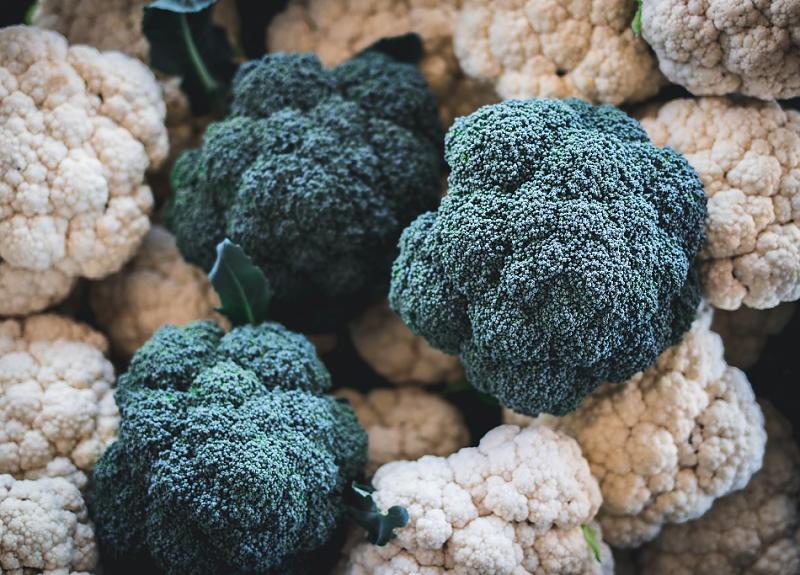 Colorful heads of broccoli and cauliflower grown in Harvest Green's Village Farm.
