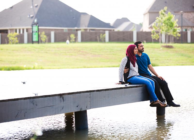 A couple sits at the dock at one of Harvest Green's lakes.