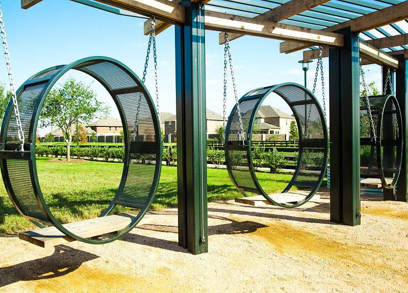 The playground at Harvest Green features a unique circular swing for kids.