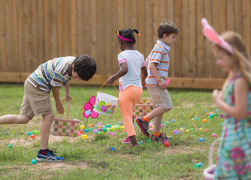 Children hunt for Easter eggs during a Harvest Green Easter resident event.