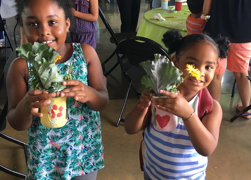 Children show their natural crafts from a family-friendly Harvest Green resident event.