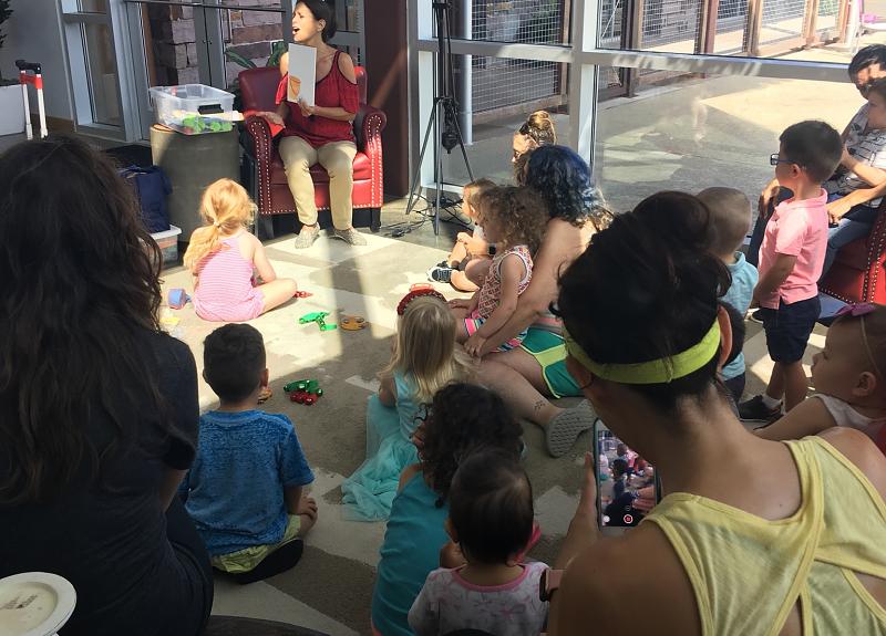 Families enjoy vibrant storytime in Harvest Green's amenity center in Fort Bend.