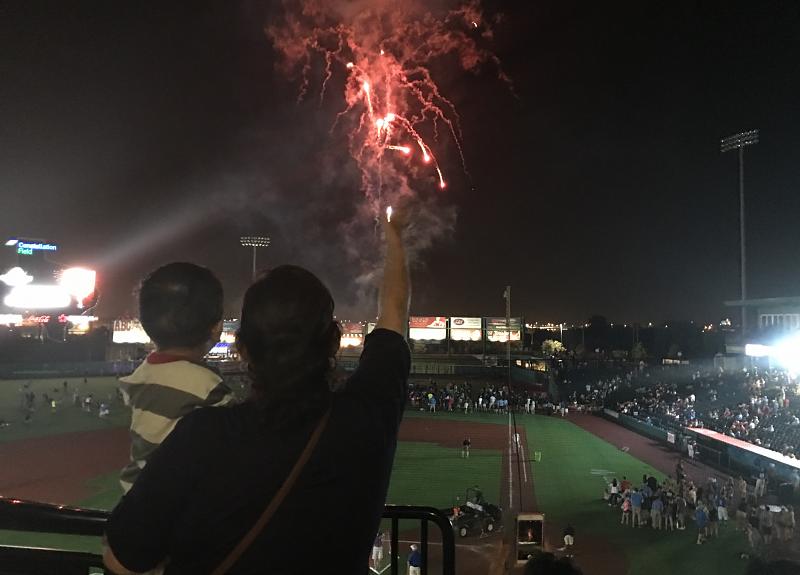 Harvest Green residents cheer with sparklers at Constellation Field in Fort Bend.