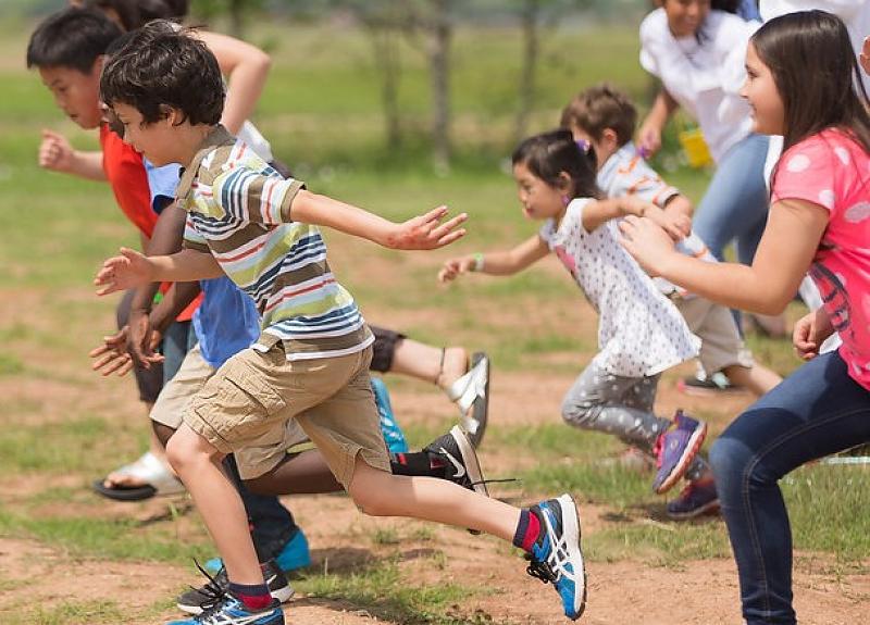 Children running in a race event at Harvest Green in Richmond, TX.